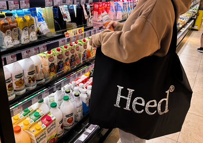 Alt text: Heed Logo Essentials XL Canvas Bag - A stylish bag featuring the iconic Heed logo, promoting mental health awareness and prioritization.""Alt text: Heed Logo Essentials XL Canvas Bag - Stylish bag with prominent Heed logo, emphasizing mental health prioritization and awareness.