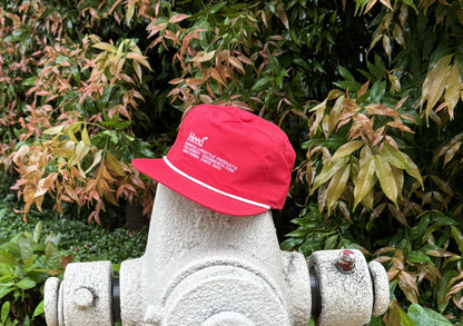 RapidDry FlexCap: Lightweight Quick-Dry Baseball Cap with Adjustable Snapback and Vintage Style - Front view of red cap with white logo detailing, featuring a flat peak design.