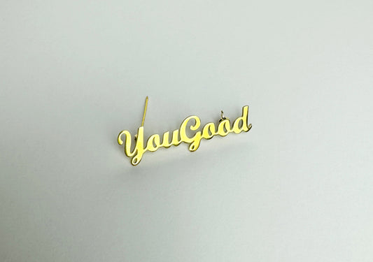 Gold script style Mental Health Streetwear Clothing Brand pin to be used on clothing and headwear. Mental Health and self care reminder to ask everyone “You good?"